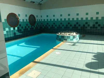 a swimming pool with a tub in a bathroom at Studio - Le D2 du Grand Tetras in Samoëns
