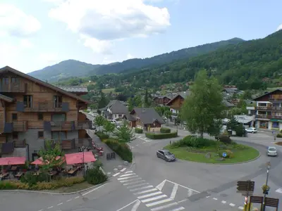 an aerial view of a town with a mountain at T2 avec mezzanine, balcon et parking à Samoëns - Pour télétravail - FR-1-629-115 in Samoëns