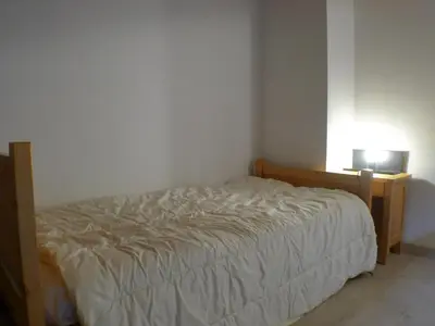 a bedroom with a bed and a desk with a lamp at T2 avec mezzanine, balcon et parking à Samoëns - Pour télétravail - FR-1-629-115 in Samoëns