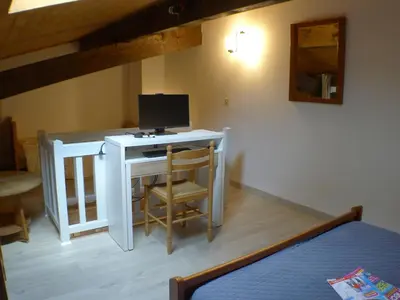 a bedroom with a desk with a computer on it at T2 avec mezzanine, balcon et parking à Samoëns - Pour télétravail - FR-1-629-115 in Samoëns