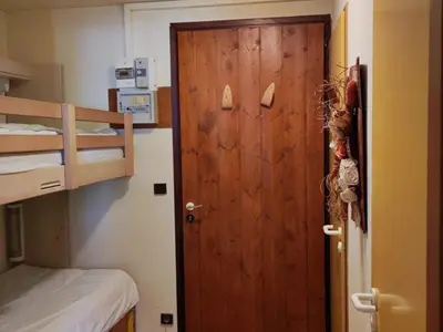 a door in a room with a bunk bed at Studio cosy 4 pers au cœur de la station, proche des pistes et commerces - FR-1-572-268 in Arâches-la-Frasse
