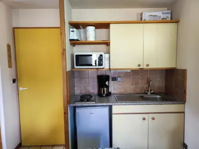 a small kitchen with a sink and a microwave at Studio cosy 4 pers au cœur de la station, proche des pistes et commerces - FR-1-572-268 in Arâches-la-Frasse