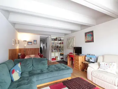 a living room with a green couch and a bedroom at Grand appartement 9 pers, près des pistes, animaux admis - FR-1-687-86 in Arâches-la-Frasse