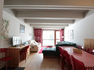 a living room with a couch and a table at Grand appartement 9 pers, près des pistes, animaux admis - FR-1-687-86 in Arâches-la-Frasse