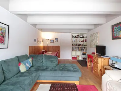 a living room with a green couch and a television at Grand appartement 9 pers, près des pistes, animaux admis - FR-1-687-86 in Arâches-la-Frasse
