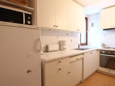 a kitchen with white cabinets and a sink and a microwave at Grand appartement 9 pers, près des pistes, animaux admis - FR-1-687-86 in Arâches-la-Frasse