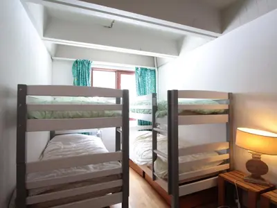 two bunk beds in a room with a lamp at Grand appartement 9 pers, près des pistes, animaux admis - FR-1-687-86 in Arâches-la-Frasse