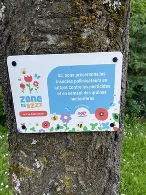 a sign on a tree with flowers on it at Three Bedroomed Chalet Apartment in Chamonix-Mont-Blanc