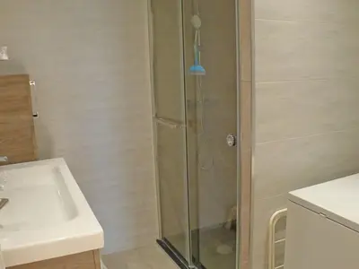 a shower with a glass door next to a sink at T2 à Samoëns, animaux acceptés, parking - FR-1-629-67 in Samoëns
