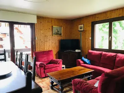 a living room with red chairs and a table at Appartement 3 pièces, 6 pers., Samoëns, avec Wifi et Parking - FR-1-629-11 in Samoëns