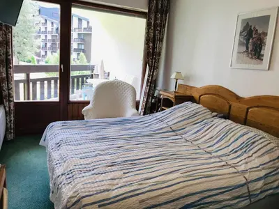 a bedroom with a bed and a large window at Appartement 3 pièces, 6 pers., Samoëns, avec Wifi et Parking - FR-1-629-11 in Samoëns
