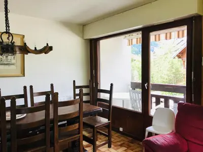 a dining room with a table and chairs and a window at Appartement 3 pièces, 6 pers., Samoëns, avec Wifi et Parking - FR-1-629-11 in Samoëns