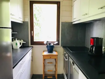 a kitchen with black counter tops and a window at Appartement 3 pièces, 6 pers., Samoëns, avec Wifi et Parking - FR-1-629-11 in Samoëns