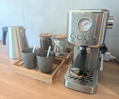 a blender sitting on top of a table with cups at Au Petit Bois in Chamonix-Mont-Blanc