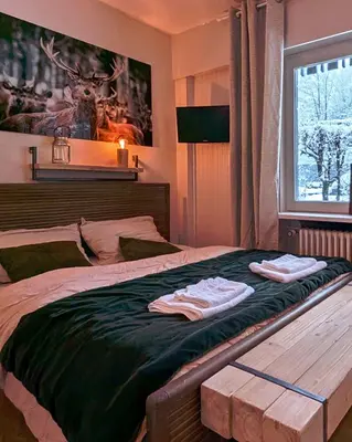 a bedroom with a bed with two towels on it at Au Petit Bois in Chamonix-Mont-Blanc