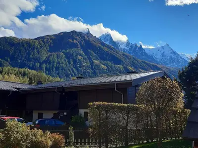 a house with a view of a mountain at T2 rez-de-jardin Chamonix avec parking et vue Mont Blanc - FR-1-517-65 in Chamonix-Mont-Blanc