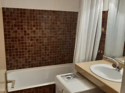a bathroom with a sink and a tub and a toilet at T2 rez-de-jardin Chamonix avec parking et vue Mont Blanc - FR-1-517-65 in Chamonix-Mont-Blanc