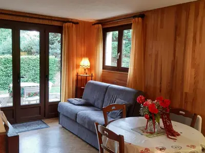a living room with a couch and a table at T2 rez-de-jardin Chamonix avec parking et vue Mont Blanc - FR-1-517-65 in Chamonix-Mont-Blanc