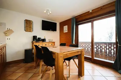 a dining room with a wooden table and chairs at Résidence Les Hauts De Chavants - Hauts de chavants Albert 1er n°1 MAE-6254 in Les Houches
