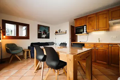a kitchen with a wooden table and chairs at Résidence Les Hauts De Chavants - Hauts de chavants Albert 1er n°1 MAE-6254 in Les Houches