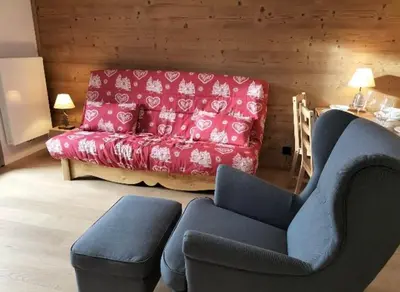 a living room with a red couch and a blue chair at White Pearl in Chamonix-Mont-Blanc