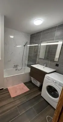 a bathroom with a sink and a washing machine at White Pearl in Chamonix-Mont-Blanc