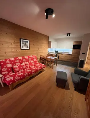 a living room with a red couch and a table at White Pearl in Chamonix-Mont-Blanc