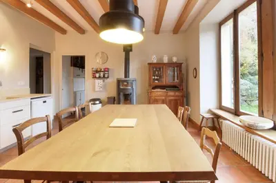 a kitchen with a wooden table and chairs at Saint Éloi - Panoramic view - Mont Joly - Central in Saint-Gervais-les-Bains