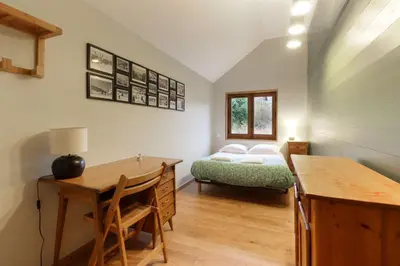 a bedroom with a bed and a desk and a table at Saint Éloi - Panoramic view - Mont Joly - Central in Saint-Gervais-les-Bains