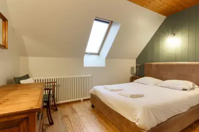 a bedroom with a bed and a desk and a window at Saint Éloi - Panoramic view - Mont Joly - Central in Saint-Gervais-les-Bains