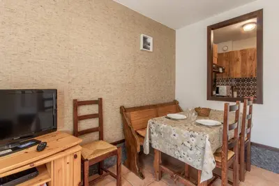 a dining room with a table and a television at Le Crétet 2 - Best views of the Mont-Blanc in Chamonix-Mont-Blanc