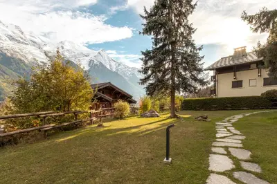 a path in front of a house with a mountain at Le Crétet 2 - Best views of the Mont-Blanc in Chamonix-Mont-Blanc