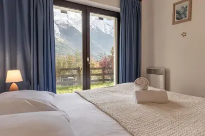 a bedroom with a bed with a view of a mountain at Le Crétet 2 - Best views of the Mont-Blanc in Chamonix-Mont-Blanc