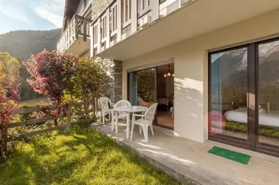 a balcony of a house with a table and chairs at Le Crétet 2 - Best views of the Mont-Blanc in Chamonix-Mont-Blanc