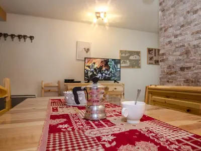 a table with a coffee pot on a red and white rug at Studio 2* central avec balcon et WiFi - FR-1-343-235 in Chamonix-Mont-Blanc