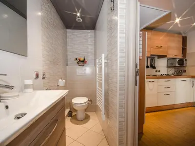 a bathroom with a toilet and a sink at Studio 2* central avec balcon et WiFi - FR-1-343-235 in Chamonix-Mont-Blanc