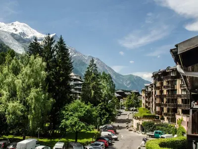 a street in a city with a snow covered mountain at Studio 2* central avec balcon et WiFi - FR-1-343-235 in Chamonix-Mont-Blanc