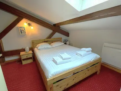 a bedroom with a bed with towels on it at Duplex centre Chamonix pour 6 avec parking et wifi - FR-1-343-240 in Chamonix-Mont-Blanc