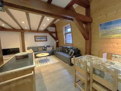 a living room with a couch and a table at Duplex centre Chamonix pour 6 avec parking et wifi - FR-1-343-240 in Chamonix-Mont-Blanc