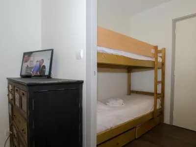 a small bedroom with a bunk bed and a dresser at Studio à Chamonix avec balcon, 4 personnes - FR-1-343-238 in Chamonix-Mont-Blanc