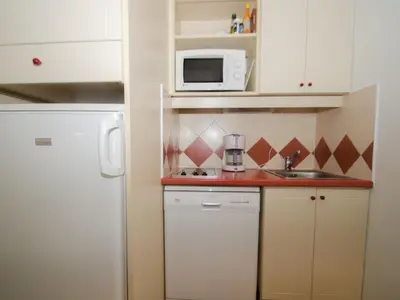 a small kitchen with a white refrigerator and a microwave at Studio à Chamonix avec balcon, 4 personnes - FR-1-343-238 in Chamonix-Mont-Blanc