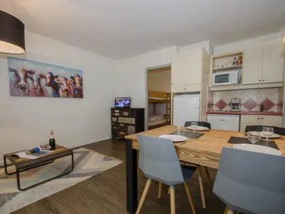 a living room with a table and chairs and a kitchen at Studio à Chamonix avec balcon, 4 personnes - FR-1-343-238 in Chamonix-Mont-Blanc
