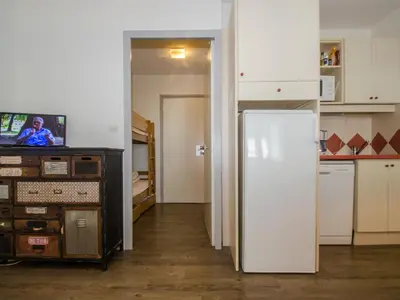 a kitchen with a white refrigerator in a room at Studio à Chamonix avec balcon, 4 personnes - FR-1-343-238 in Chamonix-Mont-Blanc