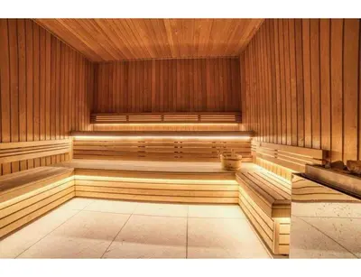 an empty sauna with wooden walls and benches in a room at Luxurious 4-room with pool, gym, spa and parking in Megève