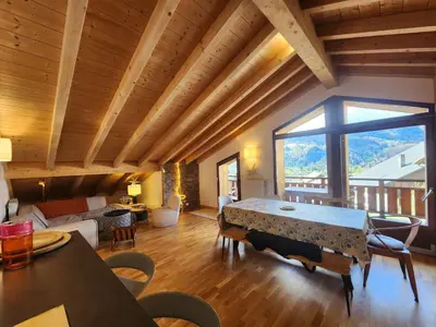 a living room with a table and a large window at Atypique T4 lumineux avec vue panoramique, 3 Ch, 6-8 pers, WIFI, parking couvert - FR-1-629-112 in Samoëns