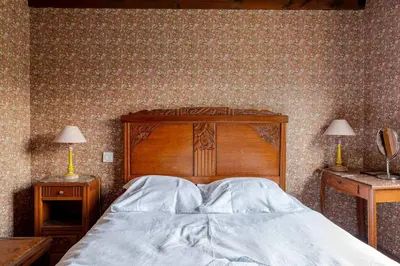 a bedroom with a wooden bed and two night stands at Chalet Les Charmilles - Vallée de Chamonix - 5 chambres in Les Houches