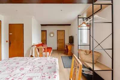 a bedroom with a bed and a room with a ladder at Chalet Les Charmilles - Vallée de Chamonix - 5 chambres in Les Houches