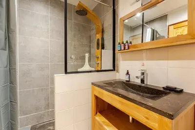 a bathroom with a sink and a shower at Chalet Les Charmilles - Vallée de Chamonix - 5 chambres in Les Houches