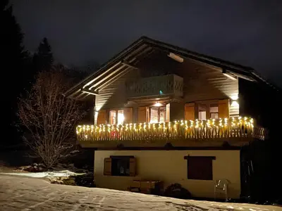 a house with a bunch of christmas lights on it at Chalet Les Charmilles - Vallée de Chamonix - 5 chambres in Les Houches
