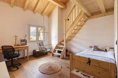 a bedroom with a bed and a desk and a ladder at Chalet Benoit - Modern Chalet 8 Pax Free Parking Mountain View - By Cozee Rentals in Chamonix-Mont-Blanc